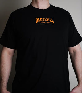 This shirt is similar to the Harley Davidson style of shirts.  It is black with orange print.  It has a small Oldskull Shirts logo on the front.  On the back it has an large eagle over a shield design with the words Oldskull Store written over it.  It is a vintage streetwear design. 