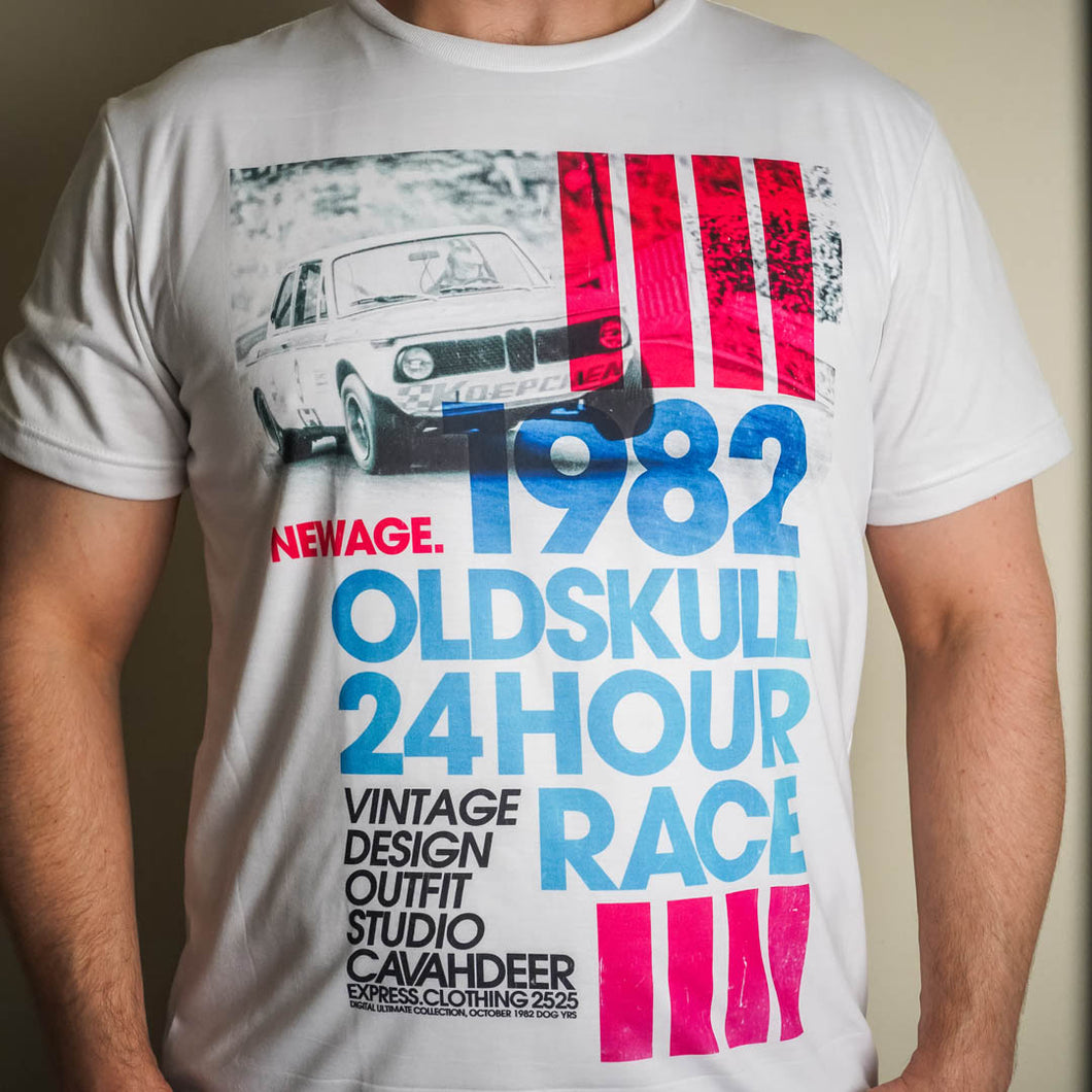 This shirt from Oldskull Shirts US features a old school racing BMW flying around the track.  It is a white streetwear shirt with the text, 1982 Oldskull 24 hour race, in blue.  In black the words, New Age Vintage Design Studio. This shirt also has Hot Pink accents.- Oldskull Store USA